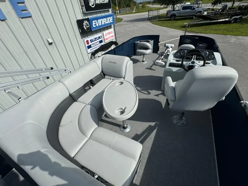 Slide: The Image of 2021 Bentley Pontoons 243 FISH 4PT interior with seating and steering console. - 11