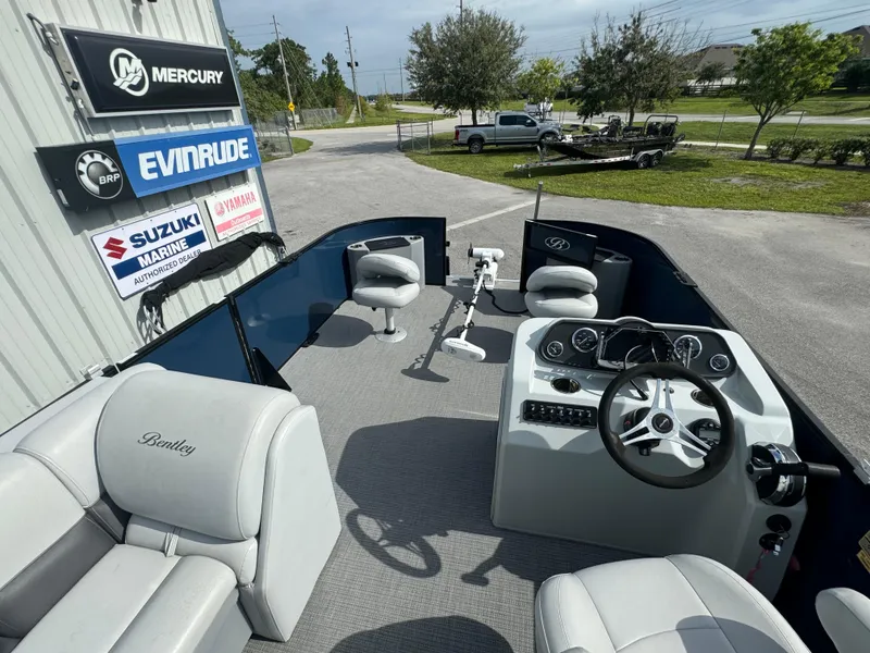 Slide: The Image of 2021 Bentley Pontoons 243 FISH 4PT interior with steering console and seating. - 12