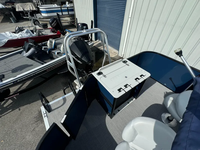 Slide: The Image of 2021 Bentley Pontoons 243 FISH 4PT boat with Mercury engine, docked near other boats. - 13