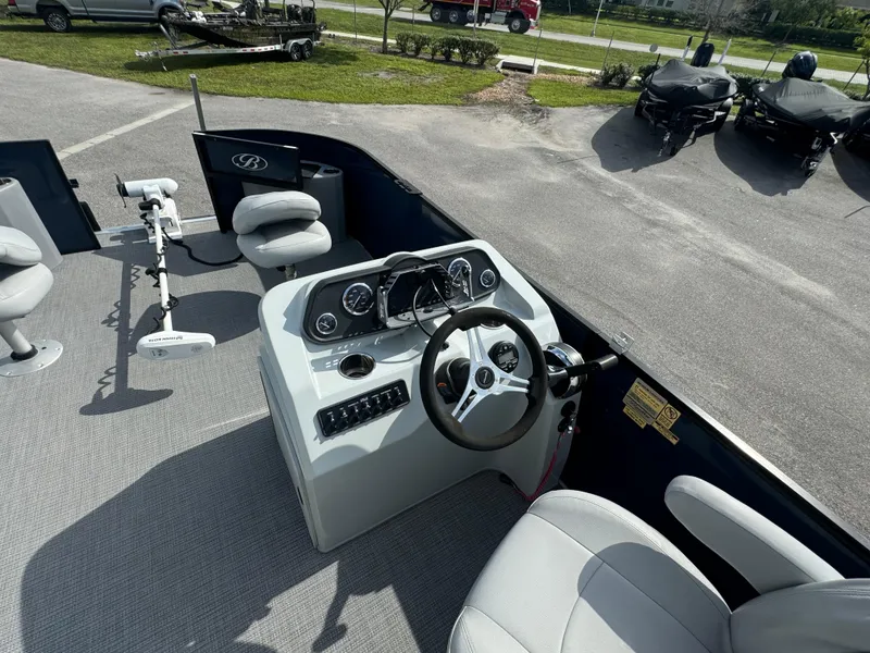 Slide: The Image of 2021 Bentley Pontoons 243 FISH 4PT boat interior with steering console and seating. - 8