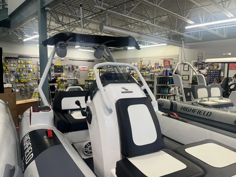 Slide: The Image of 2026 Highfield Velox 420 boat displayed in a showroom with accessories. - 13