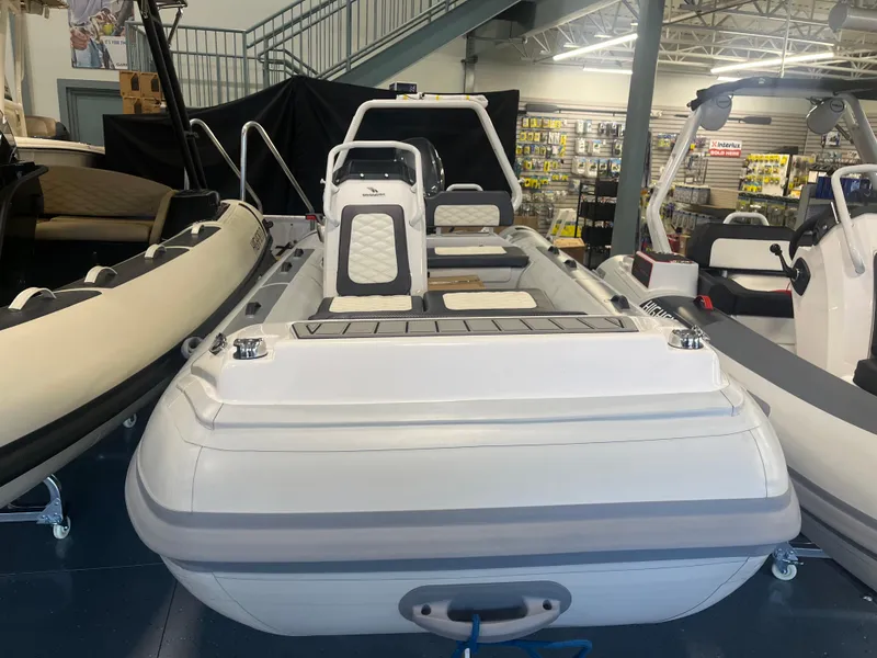 Slide: The Image of 2026 Highfield Velox 420 inflatable boat displayed in a showroom with other boats. - 15