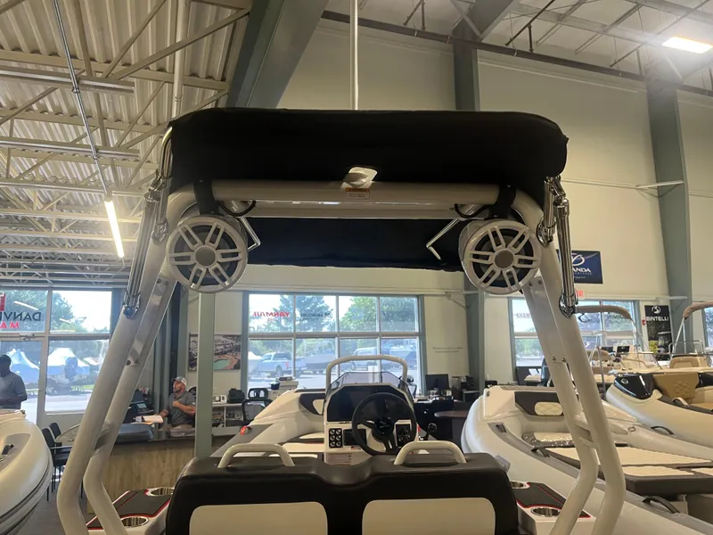 Slide: The Image of 2026 Highfield Velox 420 boat interior with speakers and seating in showroom. - 8