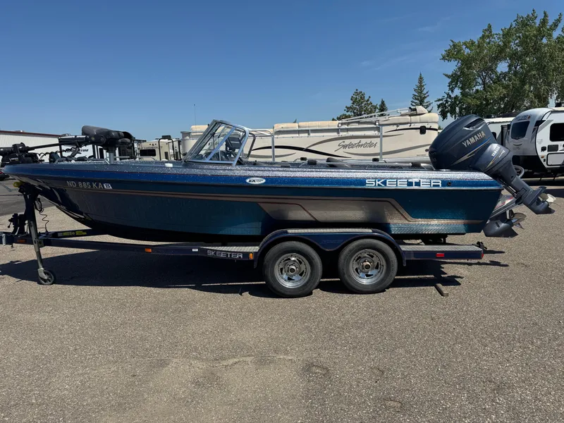 Slide: The Image of 2005 Skeeter ZX 2050 boat with Yamaha motor on trailer, parked outdoors. - 6