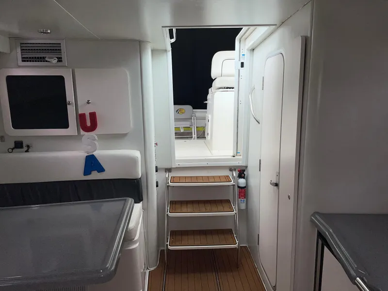 Slide: The Image of Interior of 2002 Wellcraft 330 Coastal boat with wooden steps and modern design. - 15