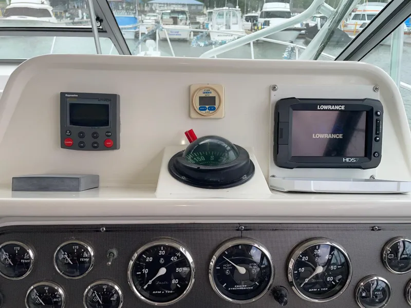 Slide: The Image of Dashboard of a 2002 Wellcraft 330 Coastal boat with navigation instruments and gauges. - 18