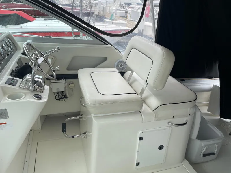 Slide: The Image of 2002 Wellcraft 330 Coastal boat interior with white captain's seat and control panel. - 20