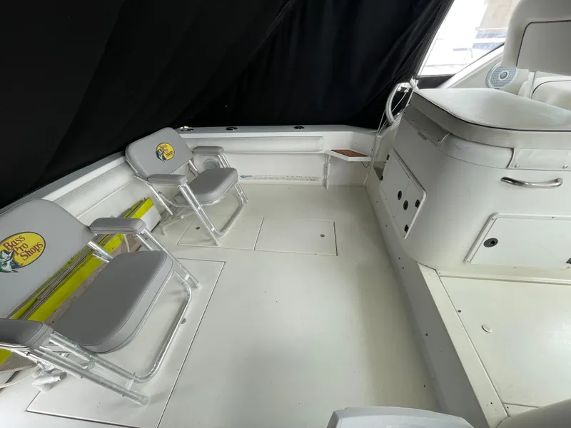 Slide: The Image of 2002 Wellcraft 330 Coastal boat interior with Bass Pro Shops chairs and white seating area. - 23