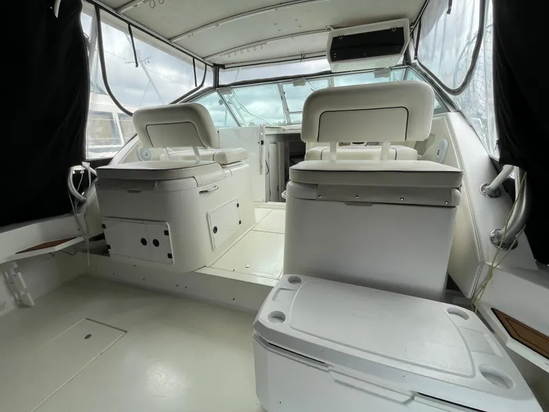 Slide: The Image of 2002 Wellcraft 330 Coastal boat interior with white seating and helm area. - 24