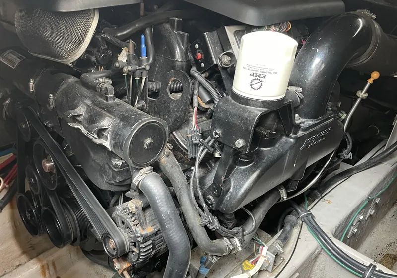 Slide: The Image of Engine of a 2002 Wellcraft 330 Coastal boat, showcasing mechanical components and wiring. - 29