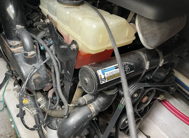 Slide: The Image of Engine compartment of a 2002 Wellcraft 330 Coastal boat, showing belts and fluid reservoir. - 30
