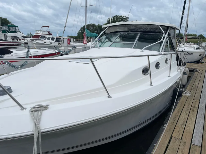Slide: The Image of 2002 Wellcraft 330 Coastal boat docked at marina, overcast sky. - 4