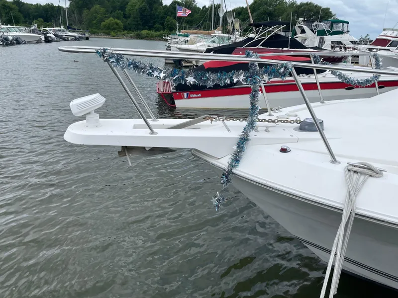 Slide: The Image of 2002 Wellcraft 330 Coastal boat decorated with tinsel, docked in a marina. - 8