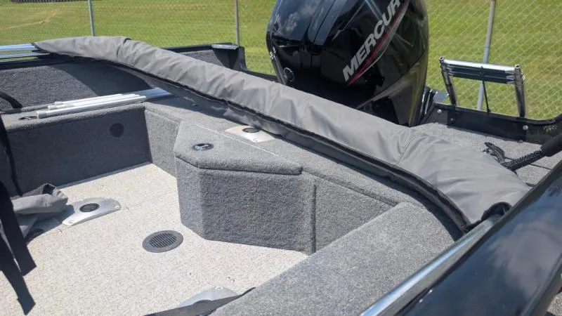 Slide: The Image of 2022 Tracker Pro Guide V 16 SC boat interior with Mercury engine. - 4