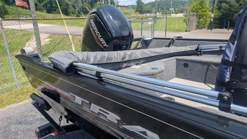 Slide: The Image of 2022 Tracker Pro Guide V 16 SC boat with Mercury engine, parked outdoors. - 9