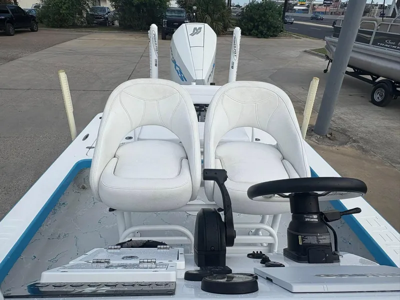 Slide: The Image of 2022 Mamba 24VX boat interior with dual white seats and steering console. - 10