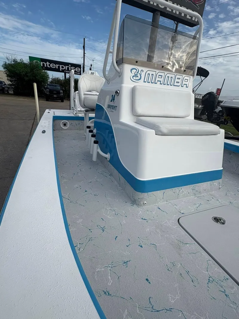 Slide: The Image of 2022 Mamba 24VX boat with blue accents, docked near Enterprise sign. - 14