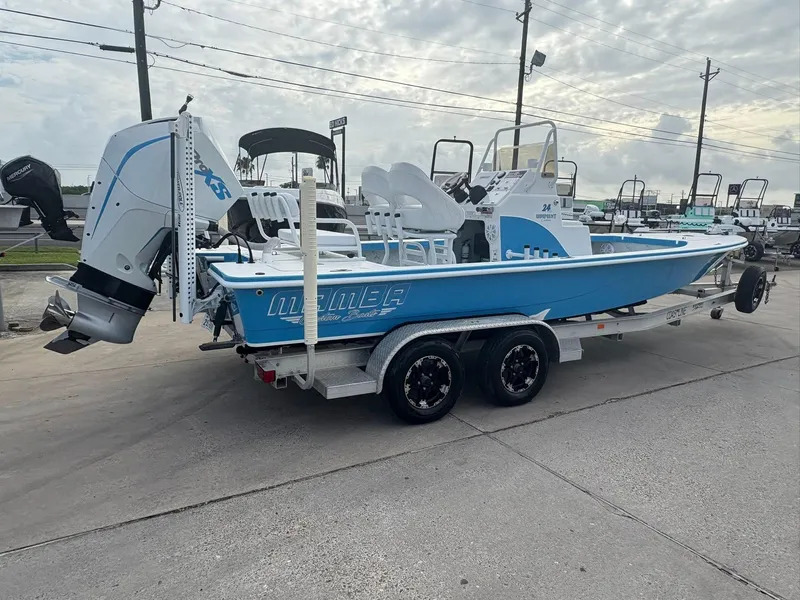 Slide: The Image of 2022 Mamba 24VX boat on trailer, blue and white design, outdoor display. - 16
