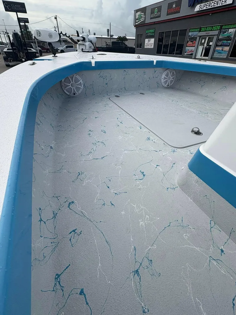 Slide: The Image of 2022 Mamba 24VX boat interior with blue accents and textured flooring. - 18