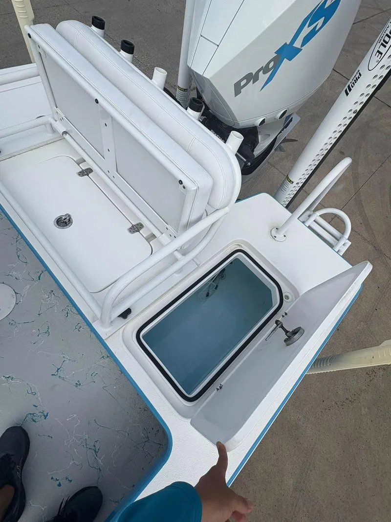 Slide: The Image of 2022 Mamba 24VX boat with open storage compartments and Pro XS engine. - 6