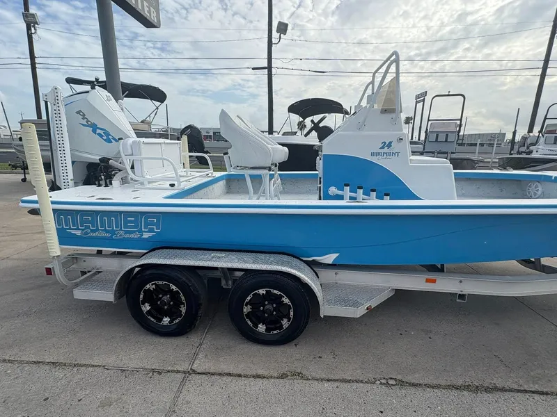 Slide: The Image of 2022 Mamba 24VX boat in blue and white on a trailer, parked outdoors. - 9