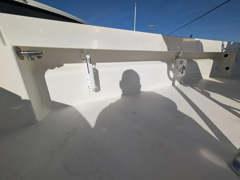 Slide: The Image of 2025 Bay Rider 239 Bay boat interior with shadow, showcasing clean white deck and fittings. - 13