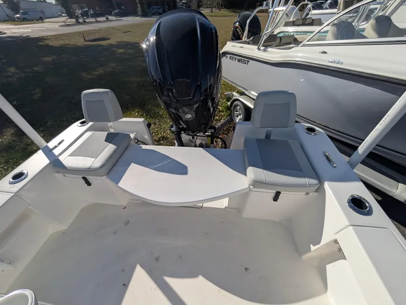 Slide: The Image of 2025 Bay Rider 239 Bay boat interior with seating and outboard motor. - 7