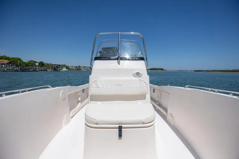 Slide: The Image of 2010 Grady-White Sportsman 180 boat on calm water under clear blue sky. - 12