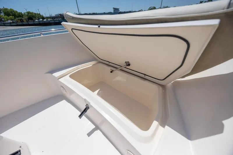 Slide: The Image of Open storage compartment on a 2010 Grady-White Sportsman 180 boat, near a waterfront. - 15