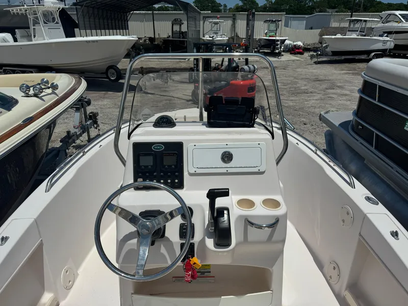 Slide: The Image of 2010 Grady-White 180 Sportsman boat dashboard with steering wheel and controls. - 3