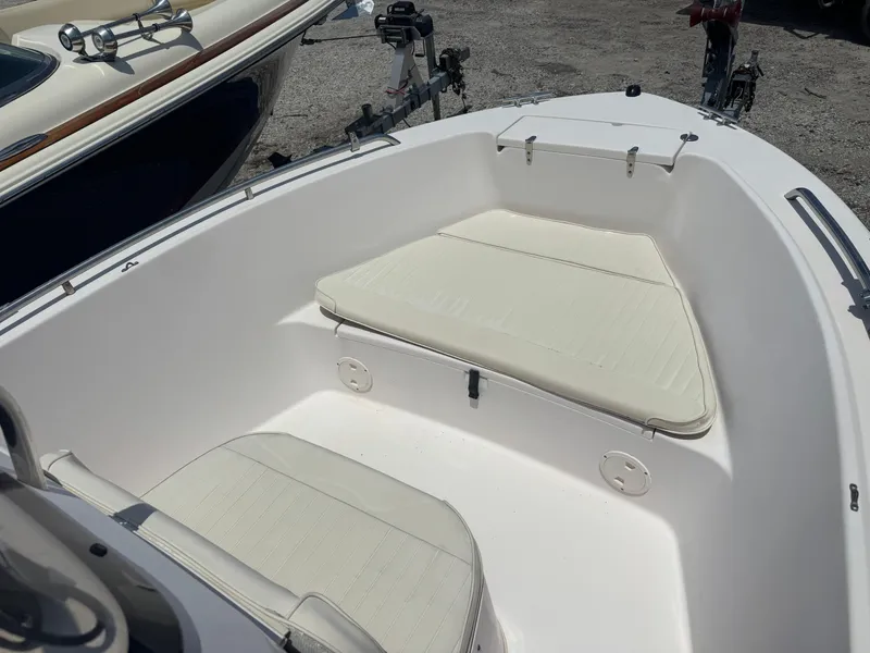 Slide: The Image of 2010 Grady-White 180 Sportsman boat interior with cushioned seating and storage. - 5