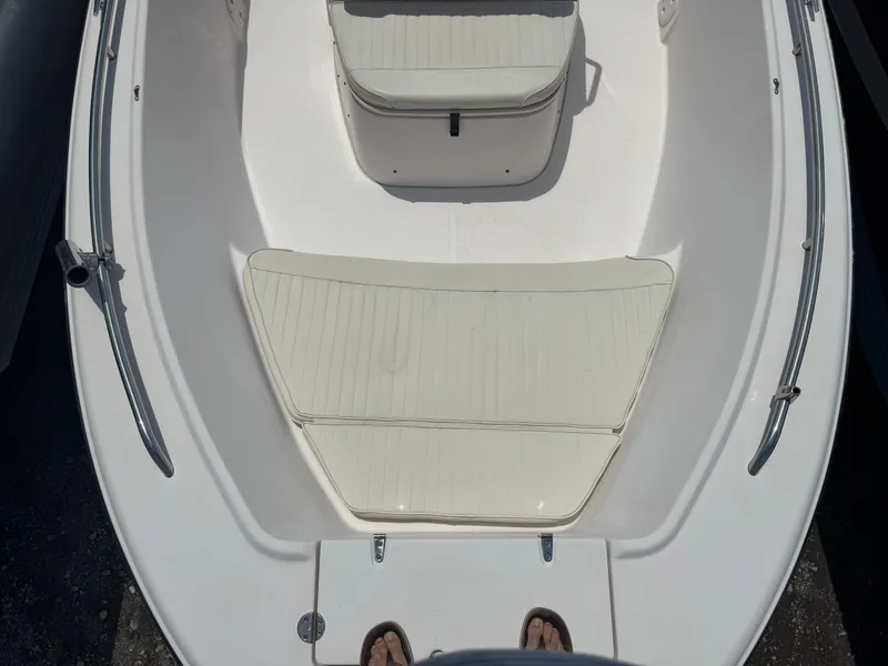 Slide: The Image of 2010 Grady-White 180 Sportsman boat interior with cushioned seating and stainless steel railings. - 7