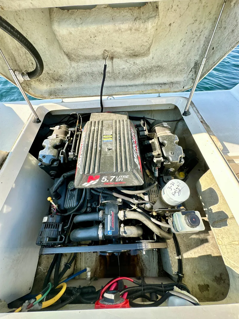 Slide: The Image of Engine compartment of a 2001 Pursuit 2460 Denali boat, featuring a 5.7L V8 engine. - 12