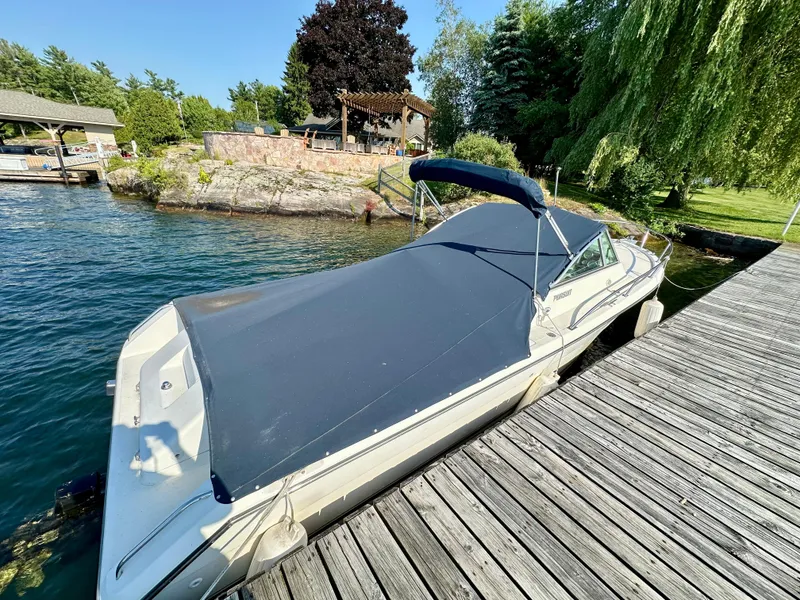 Slide: The Image of 2001 Pursuit 2460 Denali boat docked by a scenic lakeside. - 3