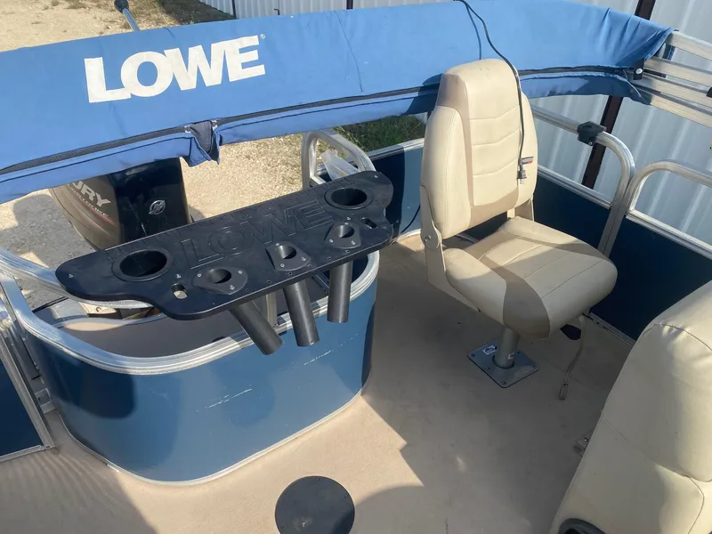 Slide: The Image of 2014 Lowe SF194 Sport Fish boat interior with seating and rod holders. - 10
