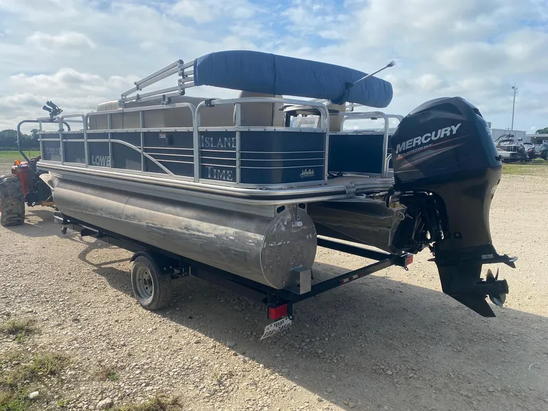 Slide: The Image of 2014 Lowe SF194 Sport Fish pontoon boat with Mercury outboard motor on a trailer. - 3