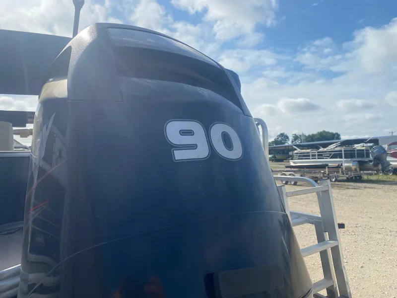 Slide: The Image of 2014 Lowe SF194 Sport Fish boat engine with "90" marking, outdoor setting. - 4