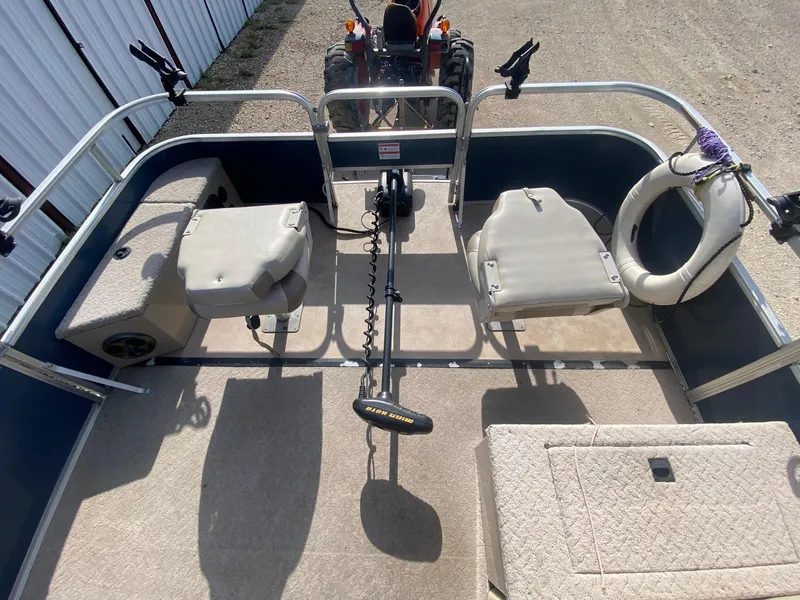 Slide: The Image of 2014 Lowe SF194 Sport Fish boat interior with seating and fishing equipment. - 6