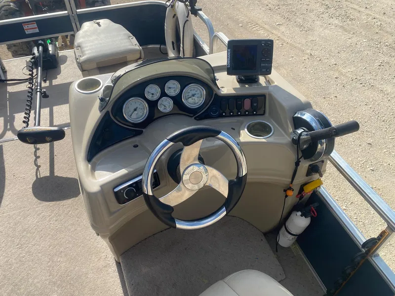 Slide: The Image of 2014 Lowe SF194 Sport Fish boat dashboard with steering wheel and control panel. - 7