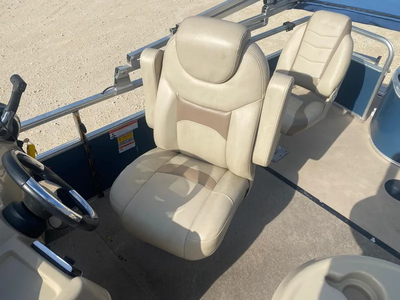 Slide: The Image of 2014 Lowe SF194 Sport Fish boat interior with beige captain's chair and steering wheel. - 8