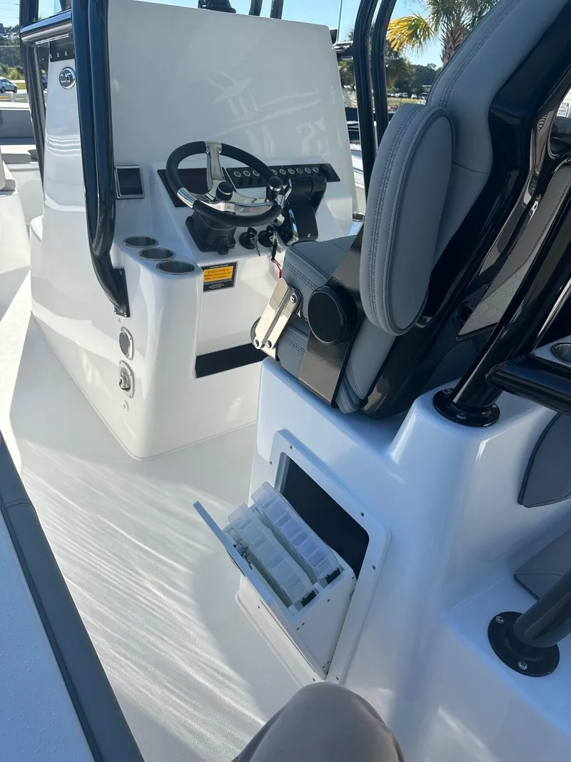 Slide: The Image of 2025 Cape Horn 28XS boat interior with steering console and storage compartments. - 13