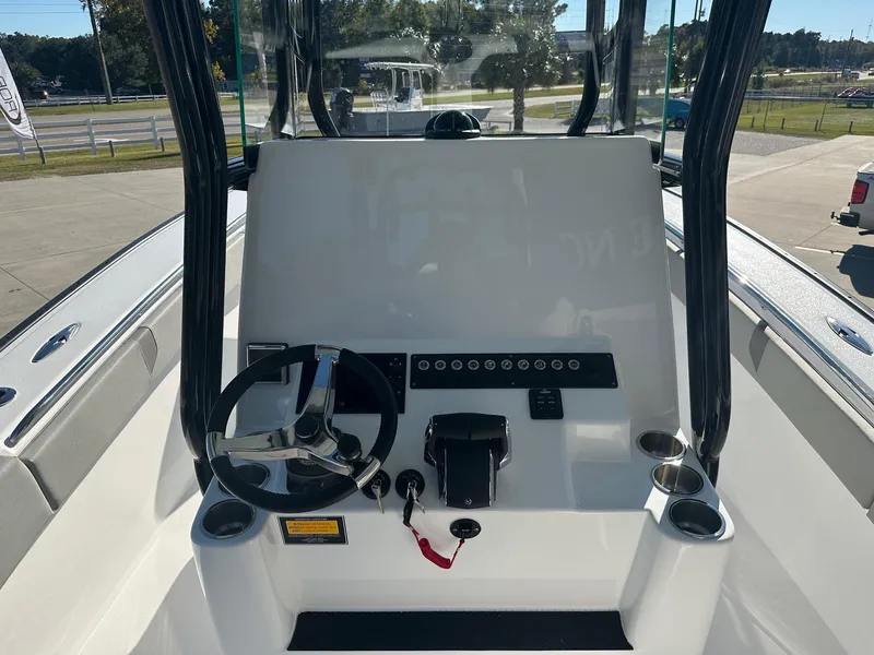 Slide: The Image of 2025 Cape Horn 28XS boat console with steering wheel and controls. - 14