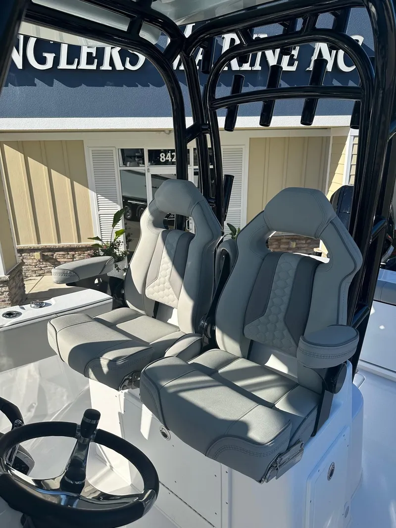 Slide: The Image of 2025 Cape Horn 28XS boat interior with dual gray seats and steering wheel. - 21