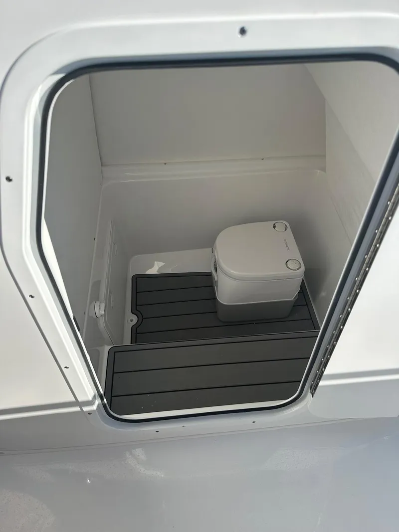Slide: The Image of 2025 Cape Horn 28XS boat interior with compact marine toilet. - 22