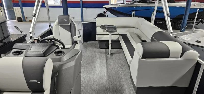 Slide: The Image of 2026 Bennington 20 SL pontoon boat interior with modern seating and steering console. - 6