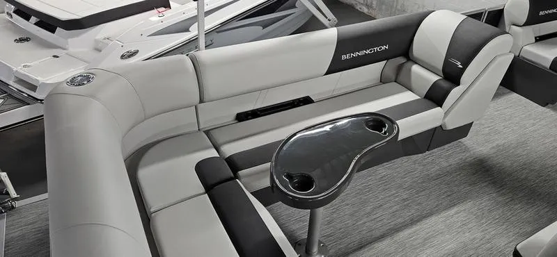 Slide: The Image of 2026 Bennington 20 SL boat interior with sleek seating and modern table design. - 9