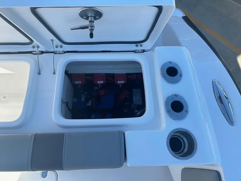 Slide: The Image of Open storage compartment on 2025 Cape Horn 28XS boat with cup holders and seating. - 9