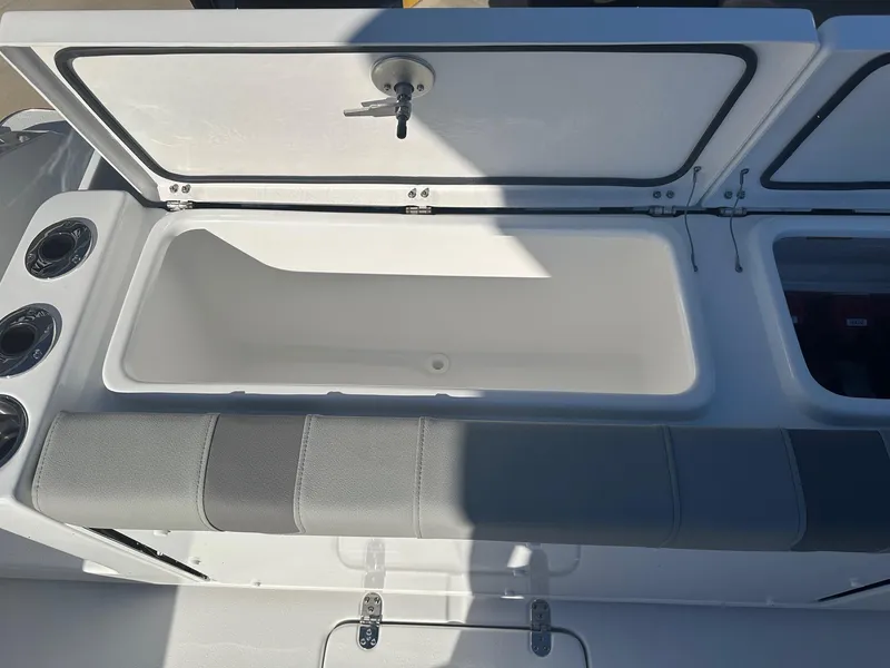 Slide: The Image of Open storage compartment on 2025 Cape Horn 28XS boat with cushioned seating. - 10