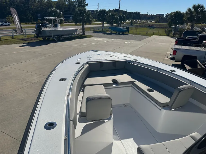 Slide: The Image of 2025 Cape Horn 28XS boat interior with seating, parked outdoors on a sunny day. - 16
