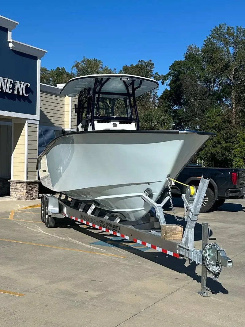 Slide: The Image of 2025 Cape Horn 28XS boat on trailer outside a building, sunny day. - 3